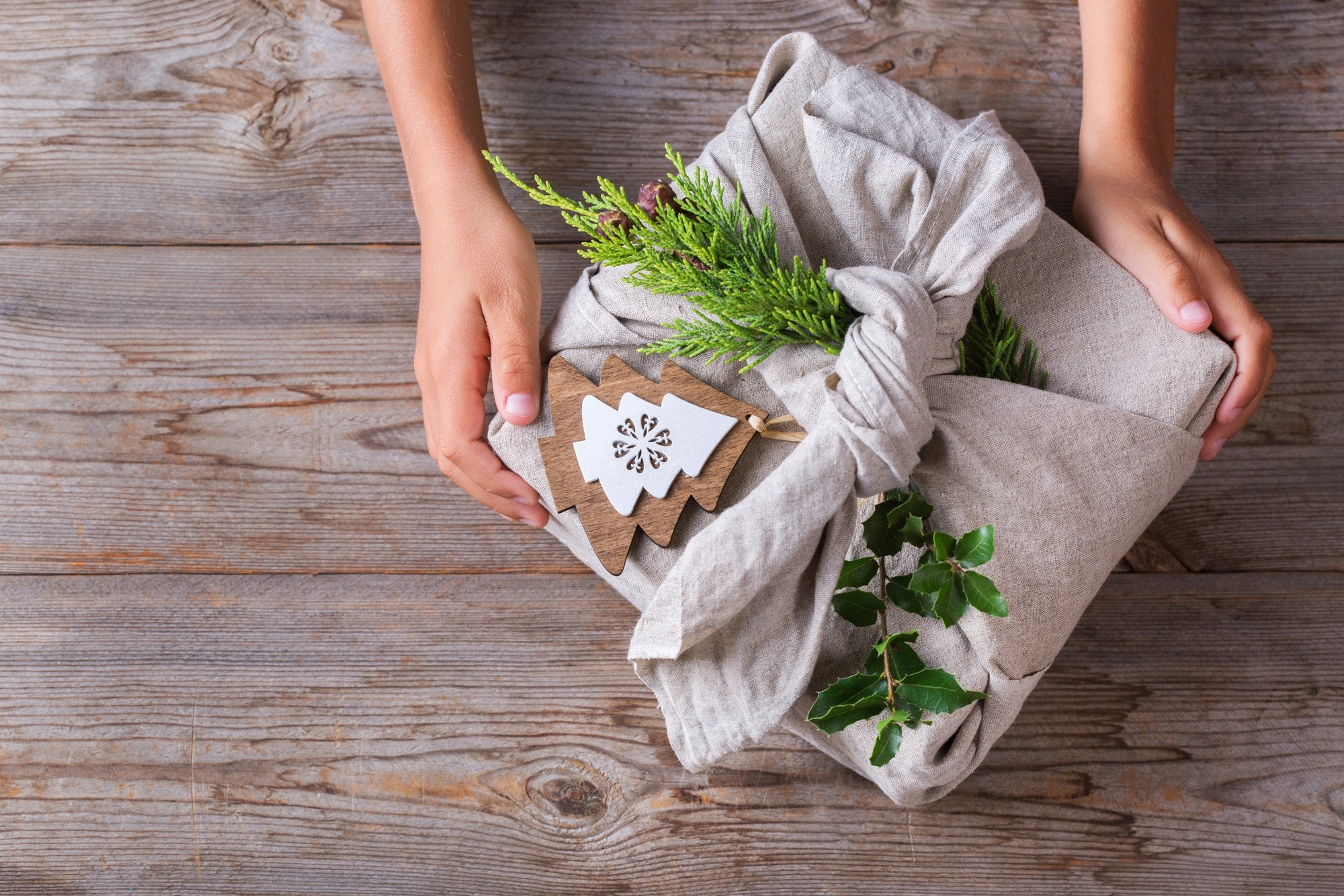Confezione regalo ecologica con tessuto riutilizzabile e decorazioni naturali