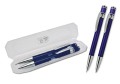 Parure  penna a sfera e mina a rotazione, fusto in alluminio colorato, clip cromata, refil nero a triplice carica. Confezione in astuccio bianco trasparente.
